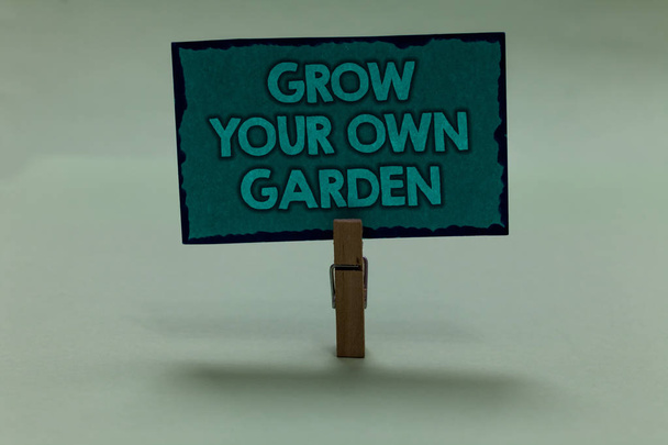 Writing note showing Grow Your Own Garden. Business photo showcasing Organic Gardening collect personal vegetables fruits paperclip grip black lined green page with outlines grey background - Photo, Image