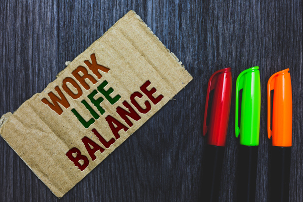 Writing note showing Work Life Balance. Business photo showcasing Division of time between working or family and leisure Cardboard with letters on grey wooden desk colorful pens laid rank - Photo, Image