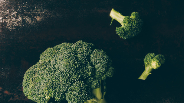 pohled shora zelené brokolice na šedý tmavý stůl - Fotografie, Obrázek