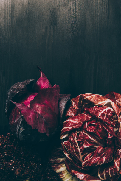 top view of red cabbage and red salad on grey dark table  - 写真・画像