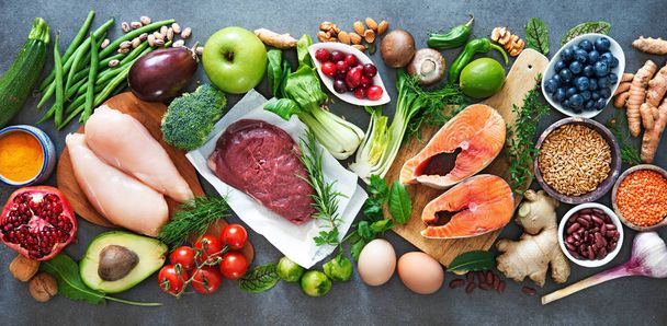 Balanced diet food background. Organic food for healthy nutrition, superfoods, meat, fish, legumes, nuts, seeds and greens  - 写真・画像