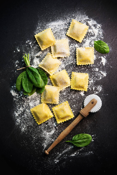 Ravioli with spinach and ricotta on dark background, top view - Photo, Image