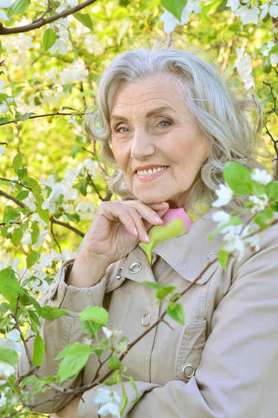 smiling elderly woman posing  in summer  park  - Photo, image