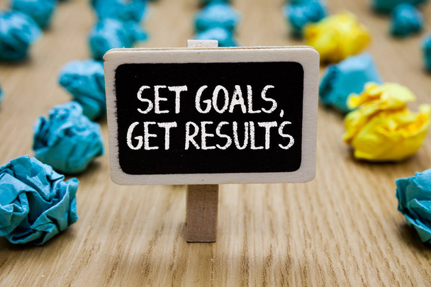 Text sign showing Set Goals, Get Results. Conceptual photo Establish objectives work for accomplish them Paperclip hold written chalkboard behind paper lumps on woody deck - Photo, Image