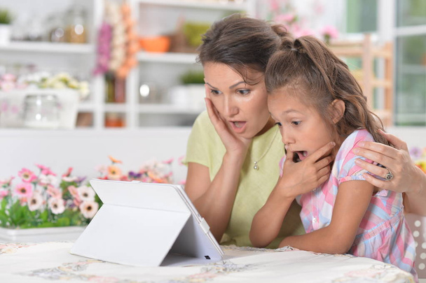 surprised mother and daughter  using modern tablet   - Photo, Image