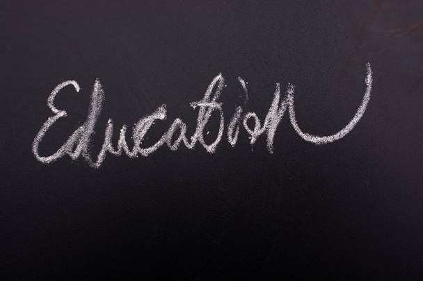 Hand written word EDUCATION with white chalk on black board - Photo, Image