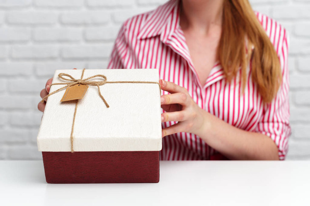 Female hands holding gift box. - Фото, зображення