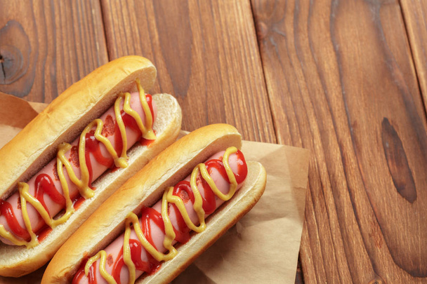 Hot dogs on wooden background - Valokuva, kuva