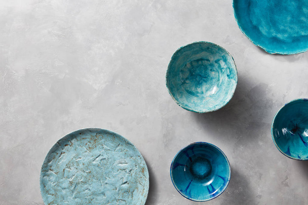 colorful porcelain handmade pottery bowls on stone gray background  - Foto, Imagem