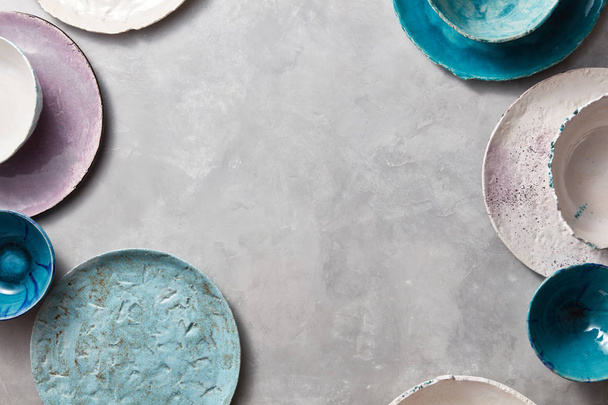 colorful porcelain handmade pottery bowls on stone gray background  - Zdjęcie, obraz