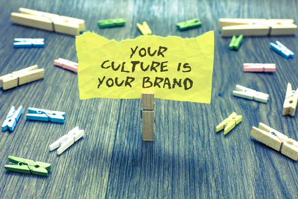 Handwriting text Your Culture Is Your Brand. Concept meaning Knowledge Experiences are a presentation card Paperclip hold written torn page many clips laid on bluish wooden floor - Photo, Image