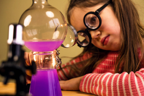 Little Girl Processing Chemical Homework Experiment with Chemical vessels. Child Education - Zdjęcie, obraz