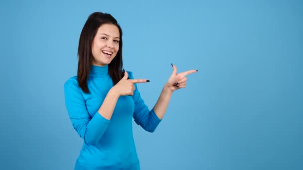 Woman advertising something by pointing to her leftwhere is copyspace available - Footage, Video