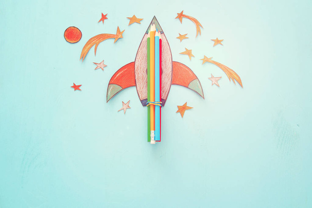 Back to school concept. rocket, space elements shapes cut from paper and painted over wooden blue background - Foto, Imagen