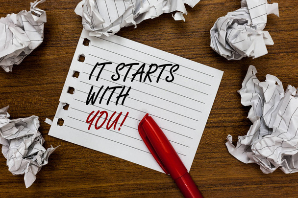 Conceptual hand writing showing It Starts With You. Business photo showcasing Motivation for starting doing something Have discipline Written white page touched red marker scattered paper lump - Photo, Image