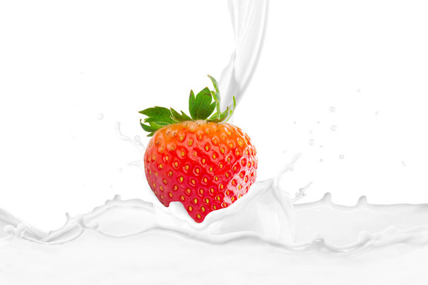 milk pouring on fresh strawberry fruit with splashes  - Фото, изображение