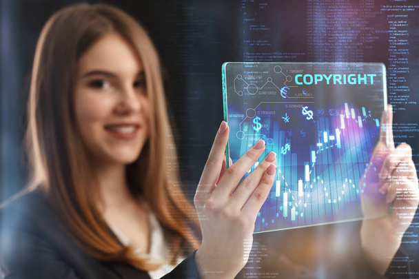 The concept of business, technology, the Internet and the network. A young entrepreneur working on a virtual screen of the future and sees the inscription: Copyright - Foto, imagen