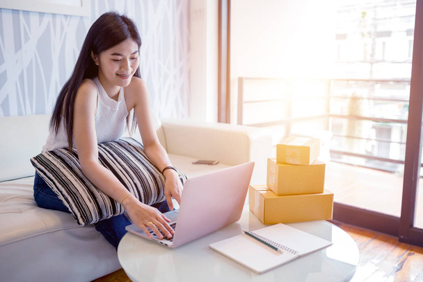 Asian young woman using laptop computer checking order product online. Shopping online concept.  - Foto, Imagem