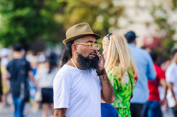 MOSCOW, RUSSIA - June 29, 2018: A Mexican bearded man in a hat talking on the mobile phone - 写真・画像