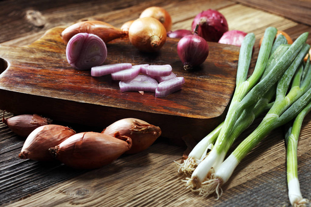 a bunch of different onions on rustic wood - Photo, Image