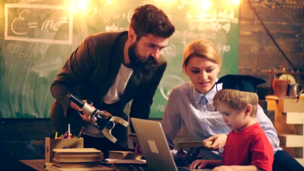 Two adult teachers bring the boy to the educational process. Learning concept. School children in uniform. Teacher in classroom. Teacher and student. Back to school. - Filmagem, Vídeo