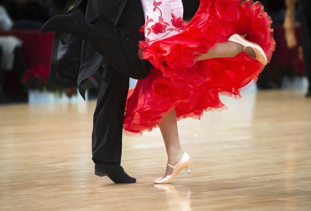 Beautiful womanish and masculine legs in active ballroom dance, indoors - Photo, Image