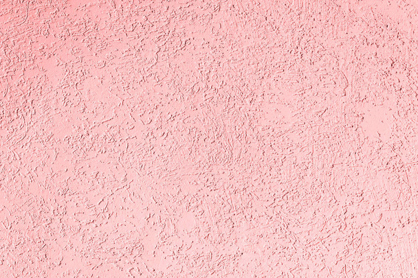 the pink texture of the surface of the wall covered with decorative plaster of the woodworm type, close-up architecture abstract background - Φωτογραφία, εικόνα