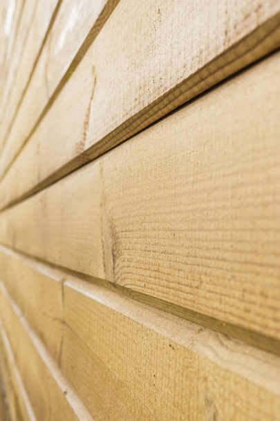 wall of yellow wooden panels, perspective view, selective focus, abstract background - Фото, изображение