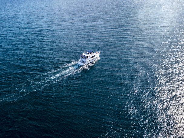 aerial motor boat isolated on a sea surface on a summer cruise trip - Fotó, kép