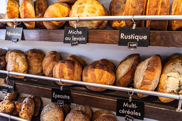 French bakery display with different kinds of bread loaves - Φωτογραφία, εικόνα