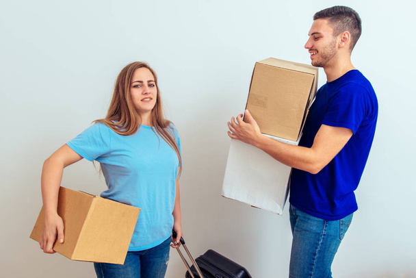 Young happy couple moving to a new home with cardboard boxes - Φωτογραφία, εικόνα