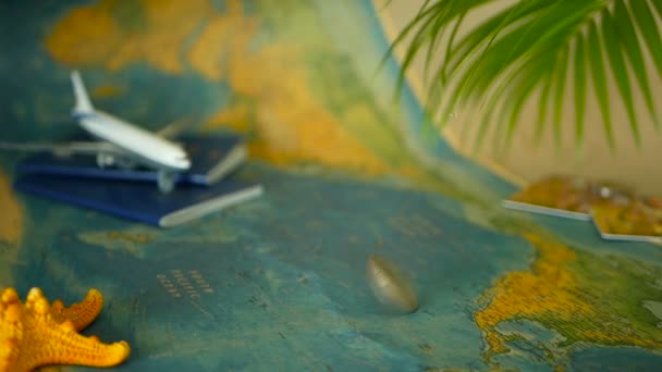 Time to travel concept. Tropical vacation theme with world map, blue passport and plane. Preparing for holliday, journey. Trip items with copy space. North America on the world map. Tourism background - Footage, Video