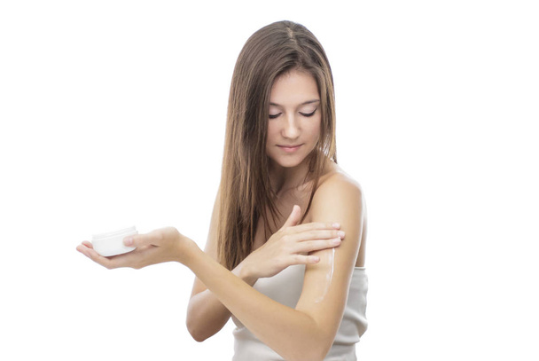 beautiful girl applying body lotion on her body - Foto, Bild