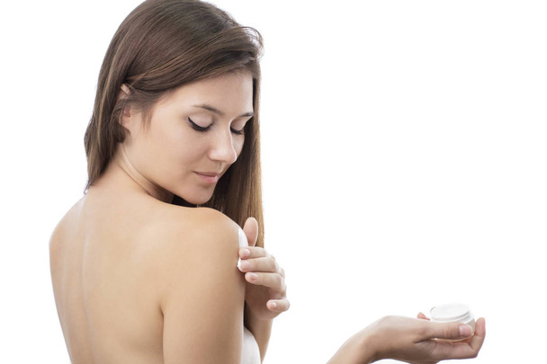 beautiful girl applying body lotion on her body - Foto, afbeelding