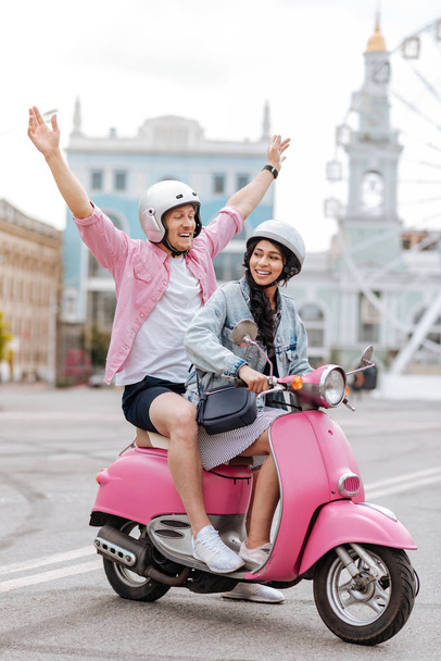 Loving positive couple having fun on motorbike - Foto, Imagen