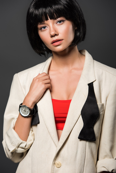 attractive young woman in stylish beige jacket looking at camera isolated on grey - Fotoğraf, Görsel