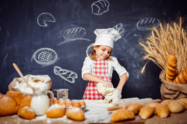 Adorable little girl in chef hat making dough - Φωτογραφία, εικόνα