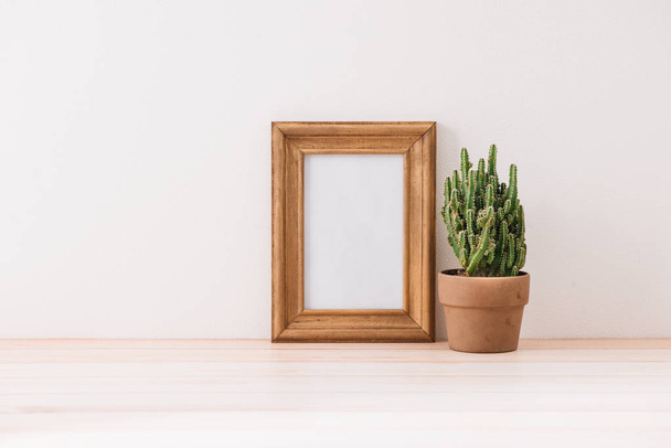 mock up frame with cactus pot on wooden floor - Fotoğraf, Görsel