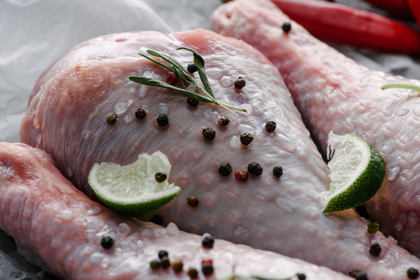 close up view of raw turkey legs with pepper corns and lime - Photo, Image