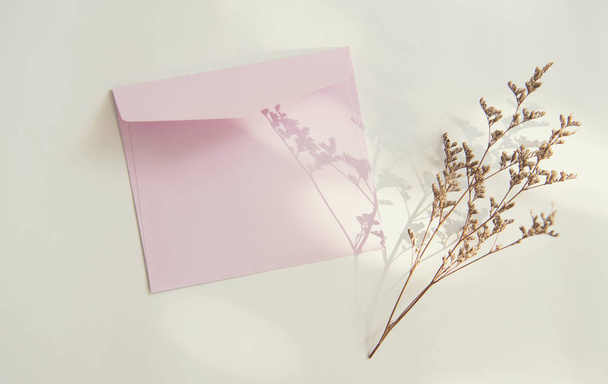 Blank white greeting card with flower. for mockup template. vintage tone. - Фото, изображение