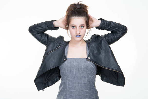 girl rock style portrait in leather clothes posing against white studio wall - Fotó, kép