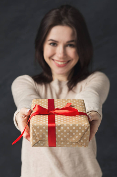 Picture of young brunette woman with gift - Zdjęcie, obraz