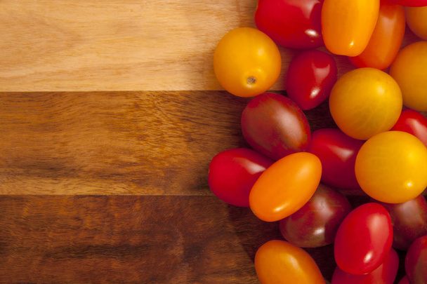 Bio colored tomato mix on wooden board - Photo, Image