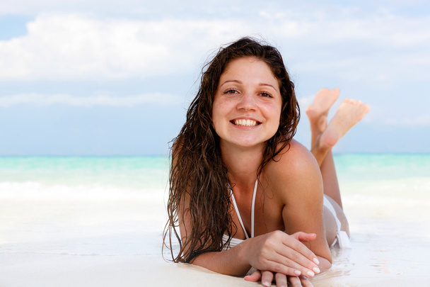 Portrait of a happy young woman posing while on the beach - Fotografie, Obrázek