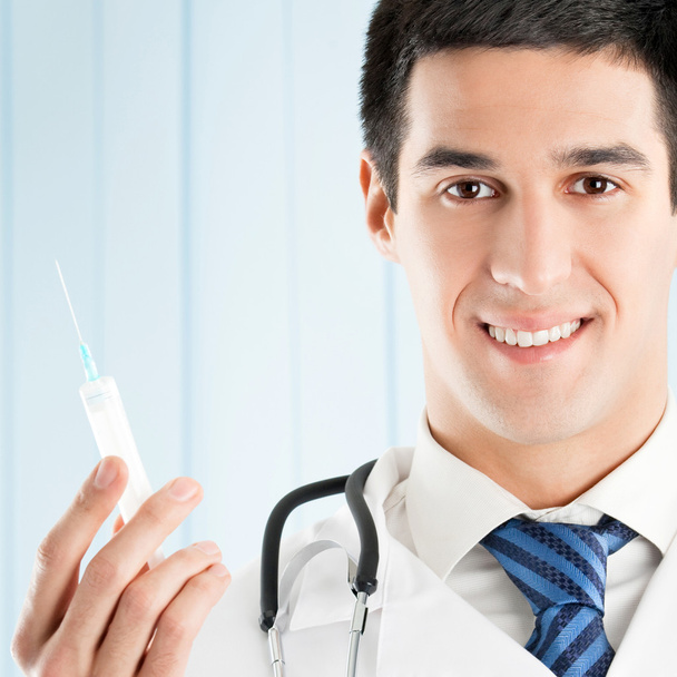 Cheerful doctor with syringe - Foto, imagen