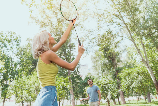couple playing badminton outdoors in summer - Fotó, kép