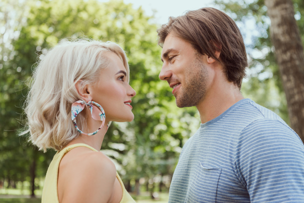 side view of couple looking at each other in park - Фото, зображення