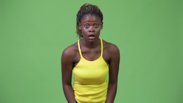 Young African woman looking shocked - Filmati, video