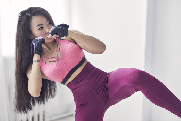 Asian woman boxing exercise with hands wrap. Beauty face and natural makeup sports bra outfit. - Photo, Image