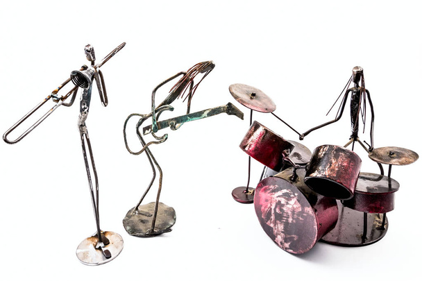 Figures of music performers made with welded black metal wire.  Creative figures of musicians, trombone, drummer and guitar are playing together. Living lines - Fotó, kép